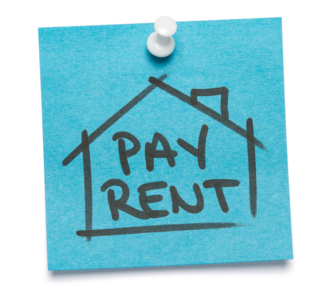 Blue sticky note written on "Pay Rent" with push pin. Isolated o white background with clipping path.